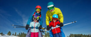 Family in ski gear posing on the slopes