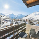 Balcony terrace overlooking the snow-covered resort and stunning scenery at Hotel Turan, Les Deux Alpes
