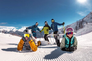 Group of happy group of friends posing on the slopes