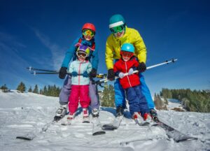 Family in ski gear posing on the slopes
